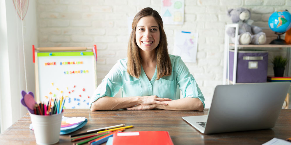 Woman, teacher sitting at desk